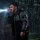 Eddie Brock (Tom Hardy) holds a flashlight in a dark scene from Venom 2: Let There Be Carnage